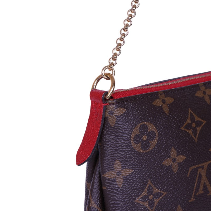 Pallas Clutch - detail cerise leer en monogram