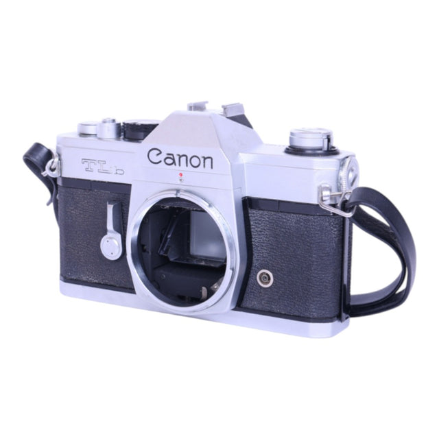 Canon TLb analoge spiegelreflexcamera body, zilver/zwart, schuin van voren met camerariem, tweedehands