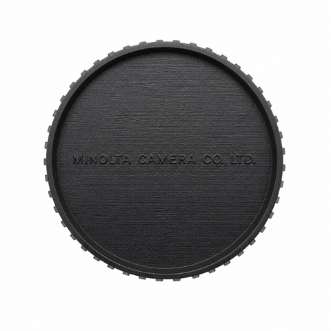 Minolta achterlensdop voor SR/MD-mount, zwart lederlook met opdruk Minolta Camera Co. Ltd. en getande rand, voorkant
