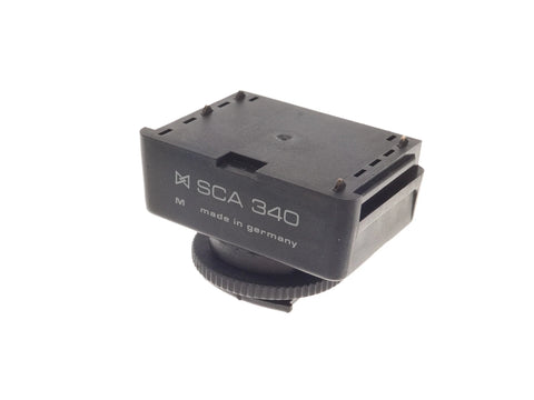 Metz SCA 340 hotshoe-adapter voor Nikon analoge camera's met F-vatting, zwarte adapter met opschrift SCA 340 M